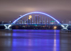 picture of a bridge at night illuminated in blue light