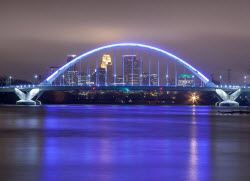 picture of a bridge at night illuminated in blue light