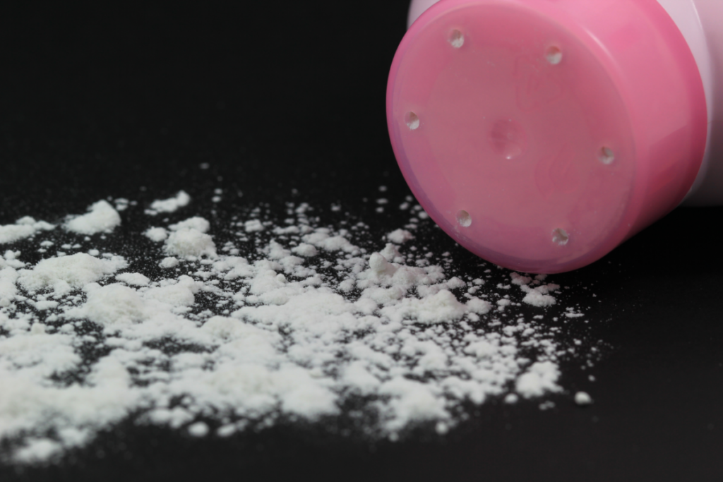 talcum powder bottle on black background