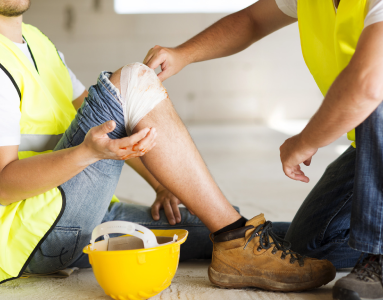 construction working getting their hurt knee bandaged