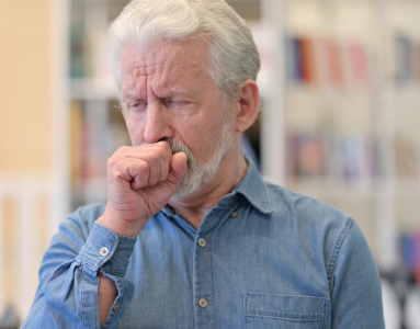 older man coughing due to mesothelioma caused by asbestos exposure