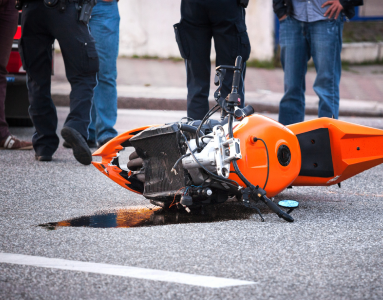 motorcycle crash scene with oil leaking out