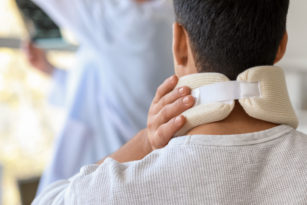 patient holding neck brace after injury