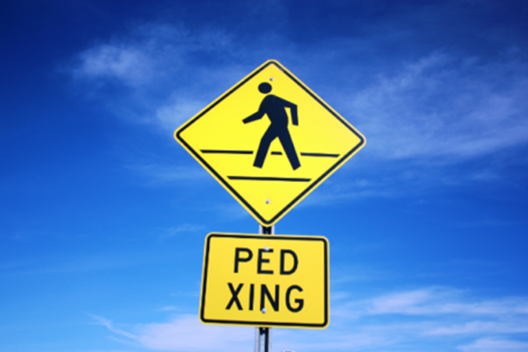 a trafic sign interpreting that pedestrians are walking