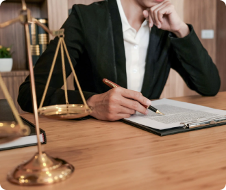 close up of attorney sitting at desk with clipboard