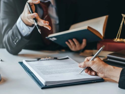 a client signing a document in front of the attorney