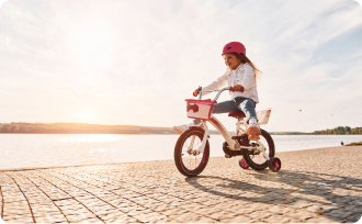 little kid riding a bike under sunlight