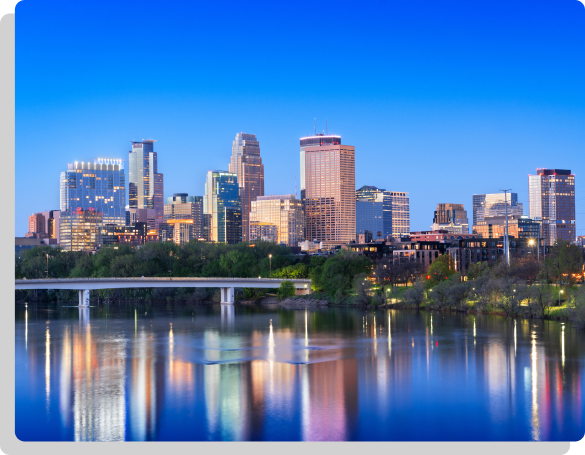 Evening skyline view of Edina, MN featuring city lights and high-rise buildings