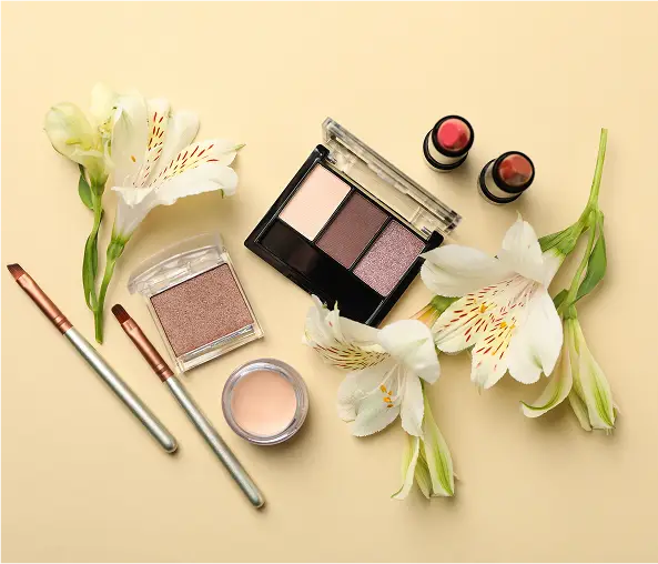 Different makeup cosmetics and flowers